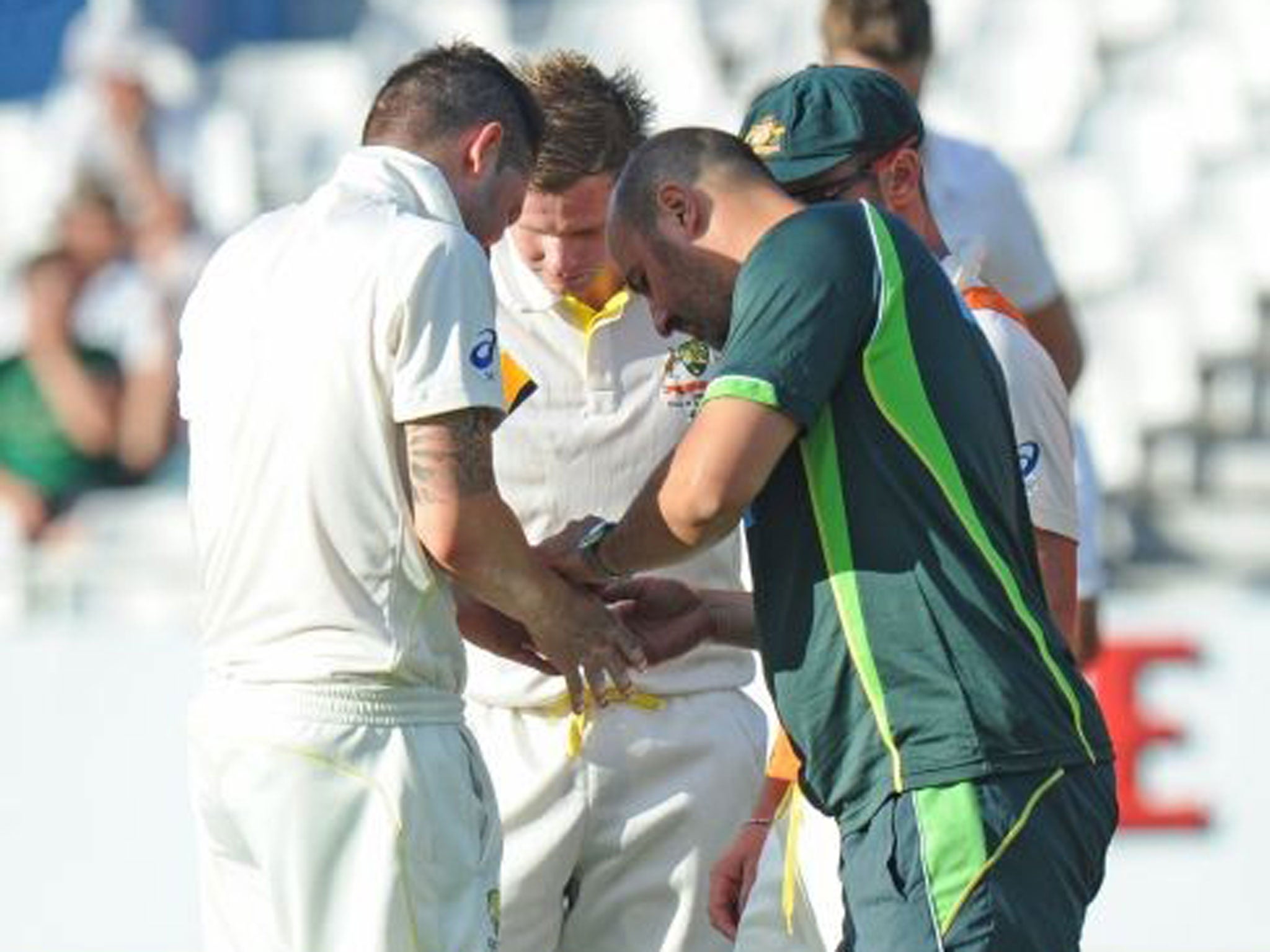 Thumbs up: Michael Clarke is treated after being hit by Morne Morkel