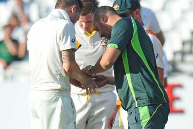 Thumbs up: Michael Clarke is treated after being hit by Morne Morkel