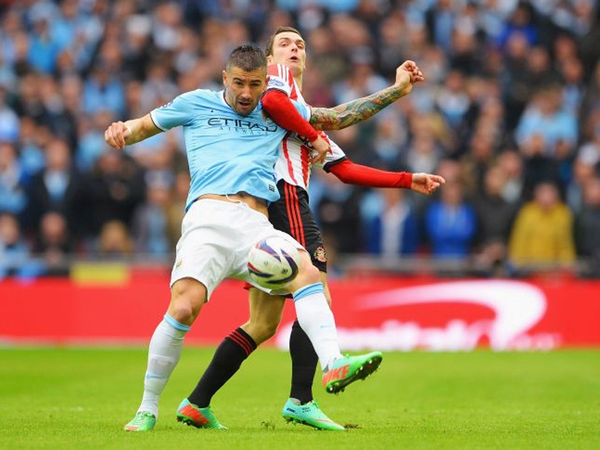 Aleksandar Kolarov of Manchester City is challenged by Adam Johnson of Sunderland during the Capital One Cup Final between Manchester City and Sunderland at Wembley Stadium (Getty)