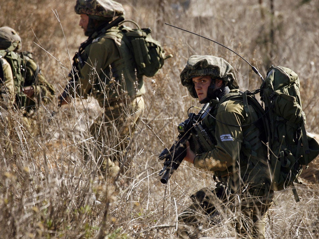 A picture taken from the Lebanese village of Adaysseh shows Israeli soldiers patrolling along the Israeli-Lebanese border on January 20, 2014. (Getty ImageS)