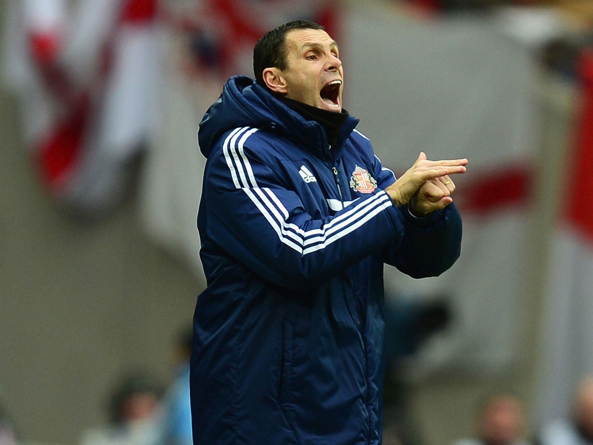 Gus Poyet makes a gesture from the touchline