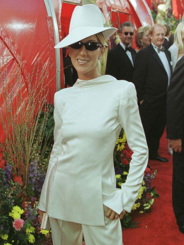 Canadian singer Celine Dion made a bold fashion statement at the 71st Academy Awards, deciding to wear her white Christian Dior tuxedo backwards with a matching fedora and diamond-encrusted sunglasses.