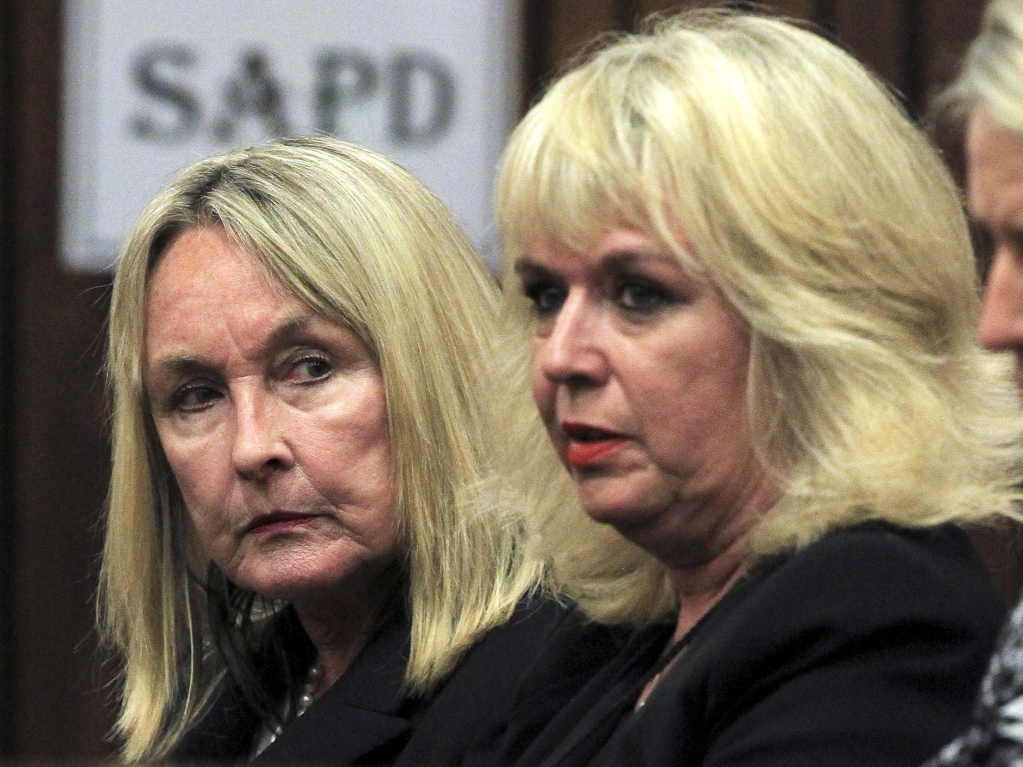 June Steenkamp (L), mother of the murdered Reeva Steenkamp, sits in court ahead of the trial of Olympic and Paralympic track star Oscar Pistorius at the North Gauteng High Court in Pretoria