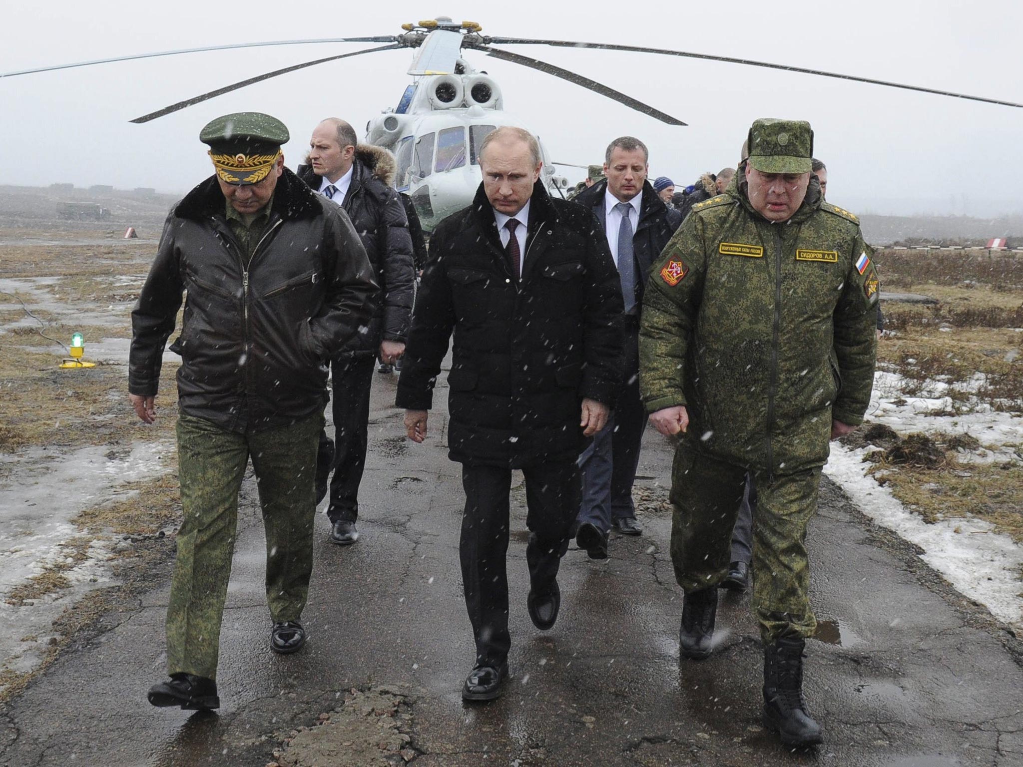 Russia's President Vladimir Putin accompanied by Russian Defence Minister Sergei Shoigu (front left)