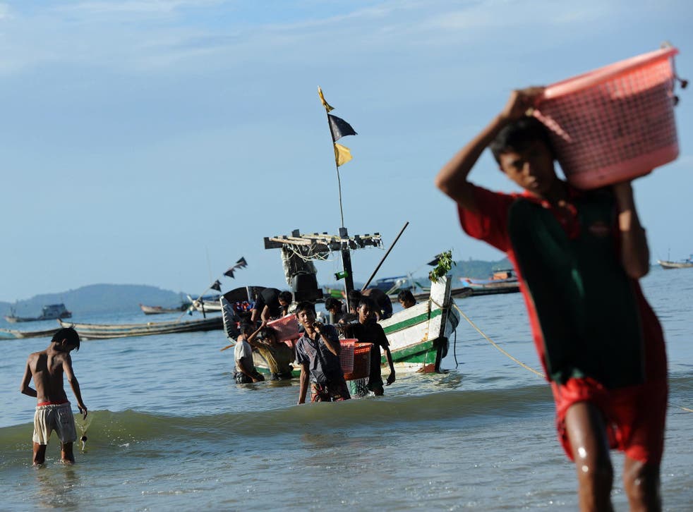 Fishermen bring their catch ashore at the beach in Ngapali, Burma’s remote major resort