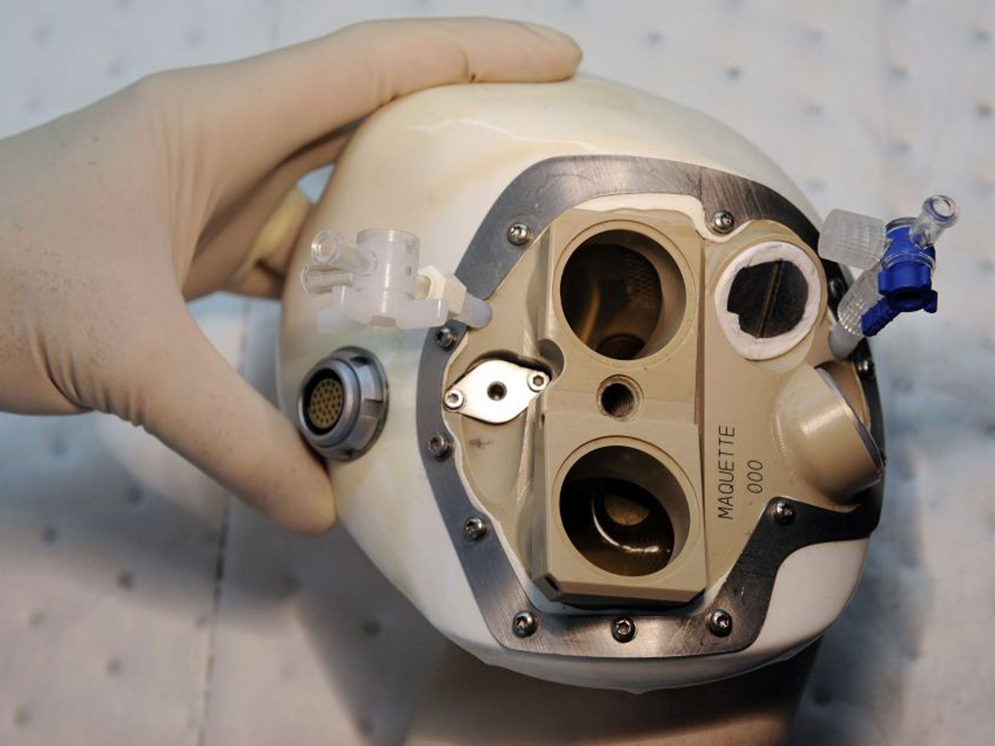 File photo shows an employee of the French company Carmat inspecting an artificial heart
