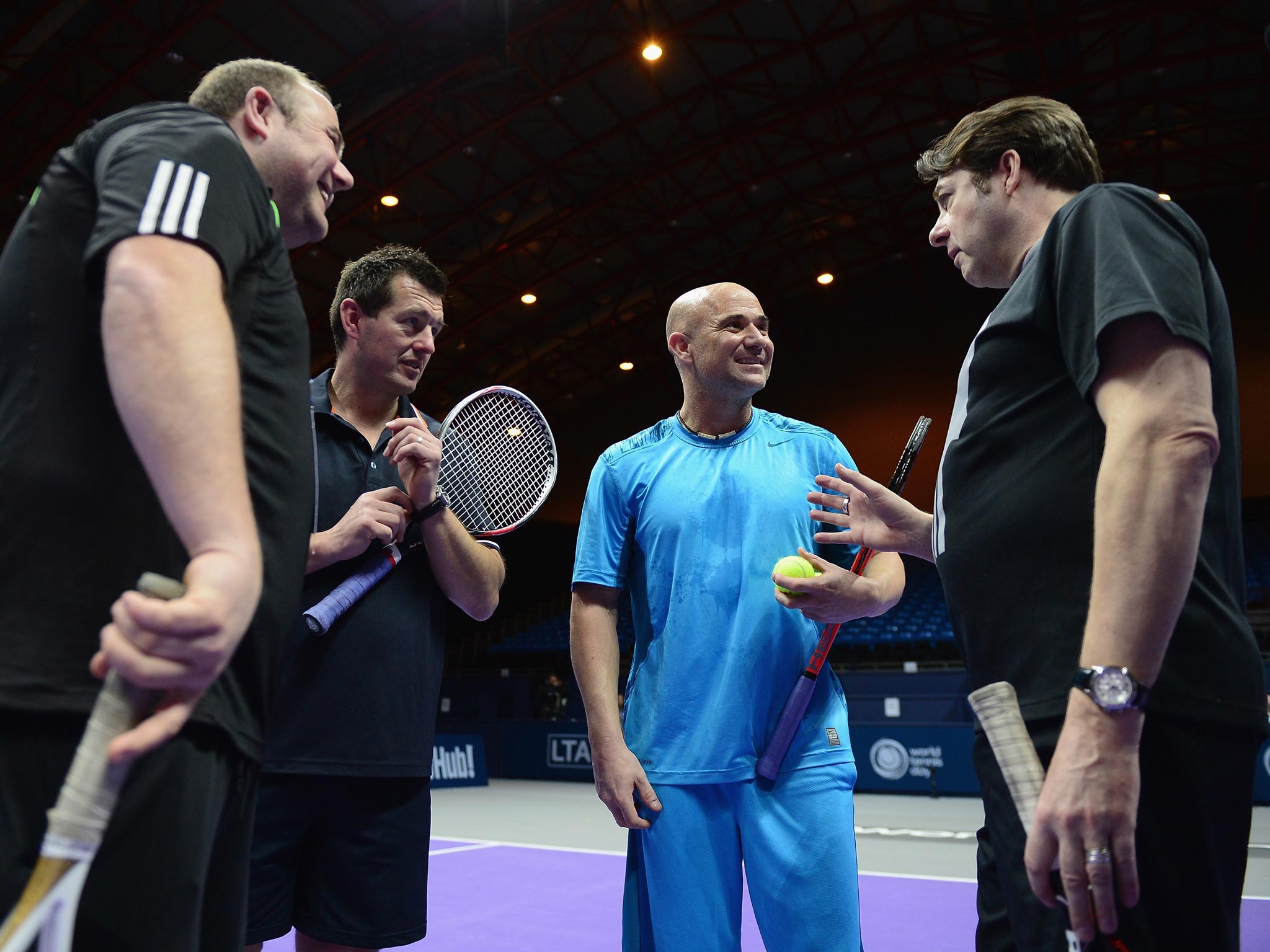 Andre Agassi (centre) chats with TV celebrity Jonathan Ross during the World Tennis Day event at Earls Court