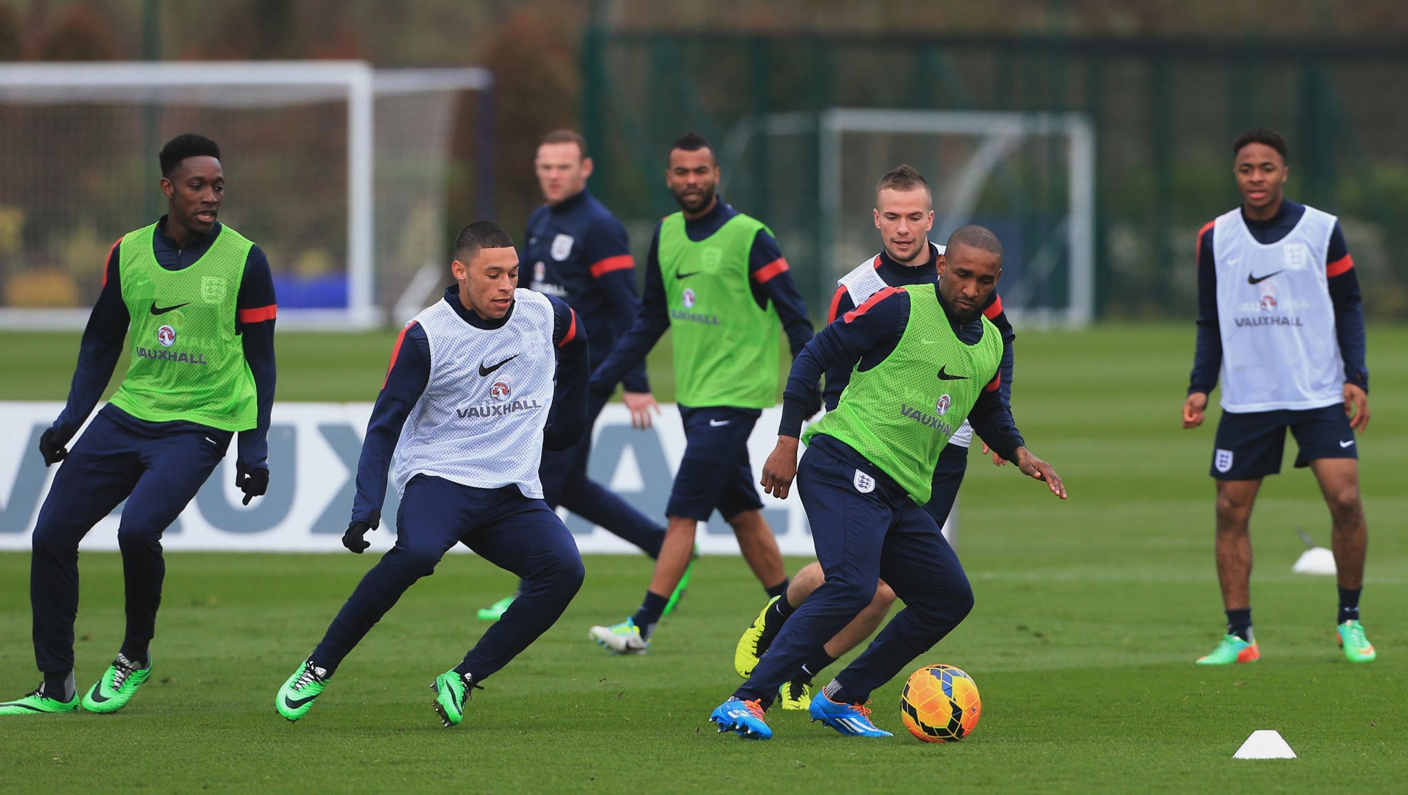 Alex Oxlade-Chamberlain (second left) closes in on Jermain Defoe during England training in Enfield