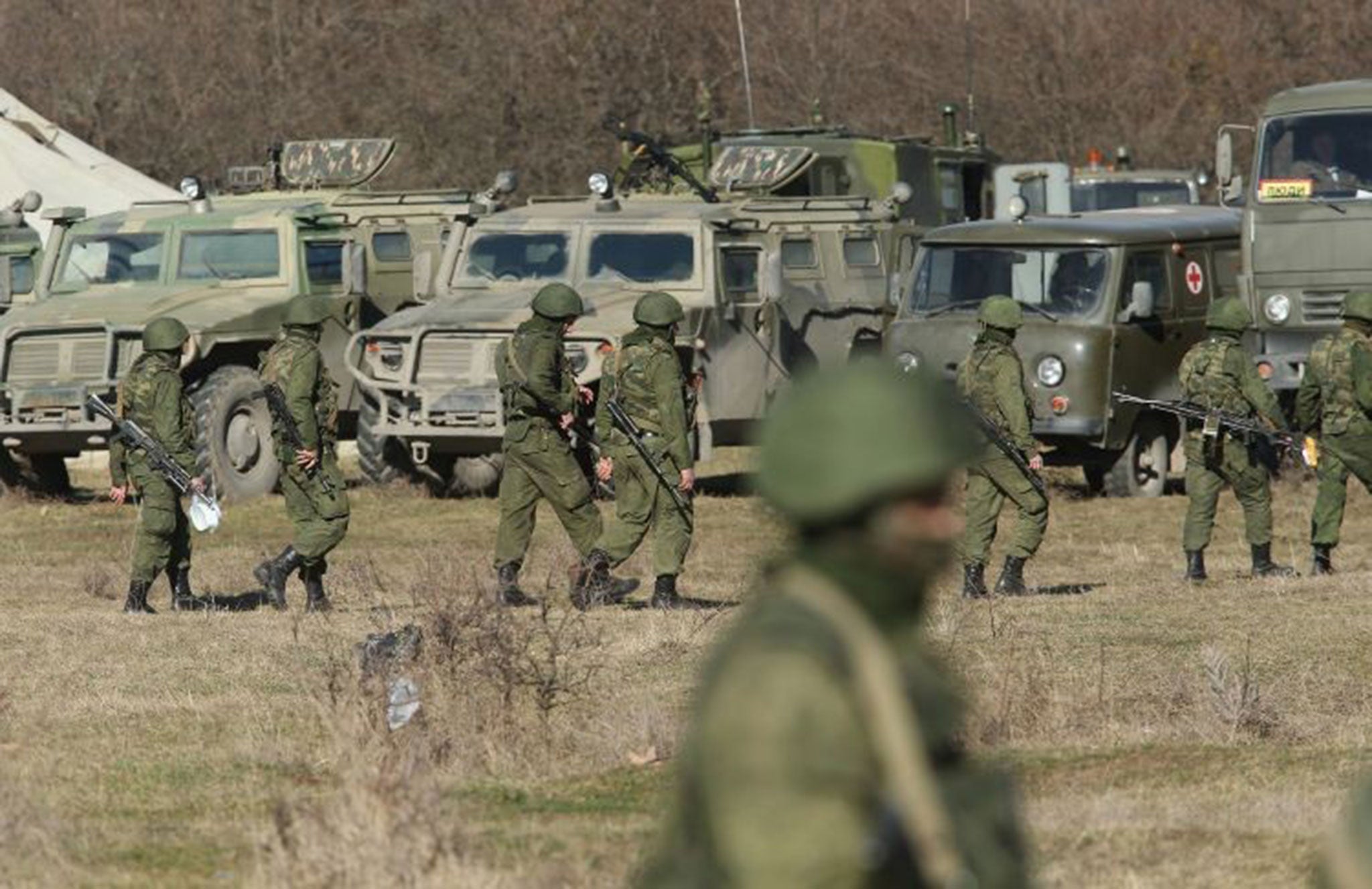 Unidentified heavily-armed soldiers – understood to be Russian troops unrelated to the incident– outside a Ukrainian military base in Crimea.