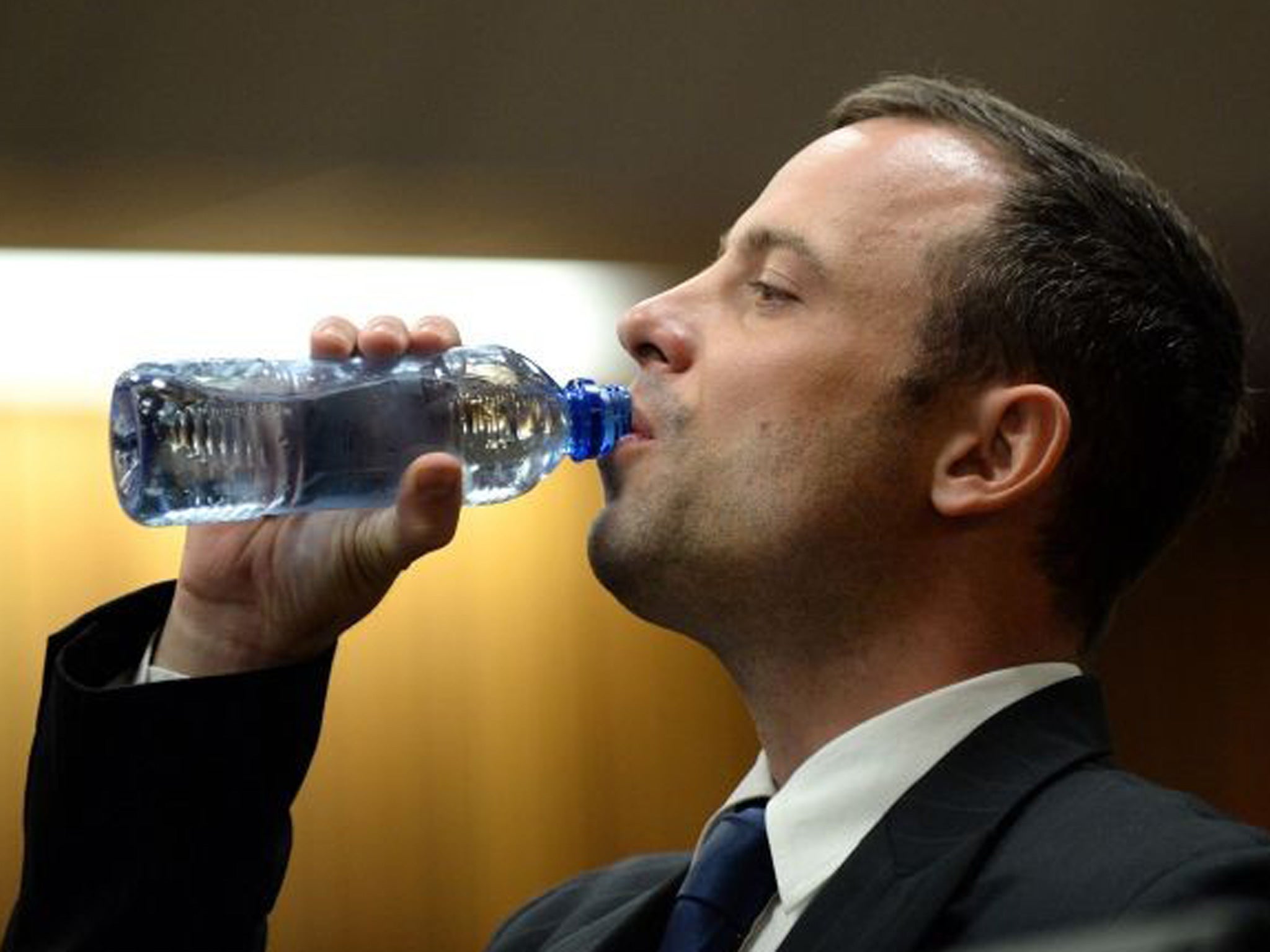 South African Paralympic athlete Oscar Pistorius, accused of murdering his girlfriend, drinks water during court proceedings on the second day of his trial at the North Gauteng High Court in Pretoria (AFP/Getty)