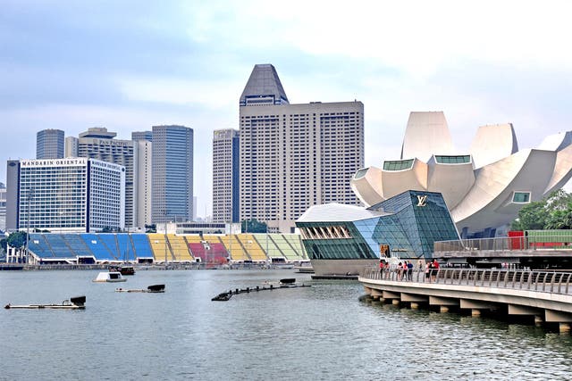 The Marina Bay promenade in Singapore. The arrival of wealthy foreigners in the booming financial centre has helped to drive up prices