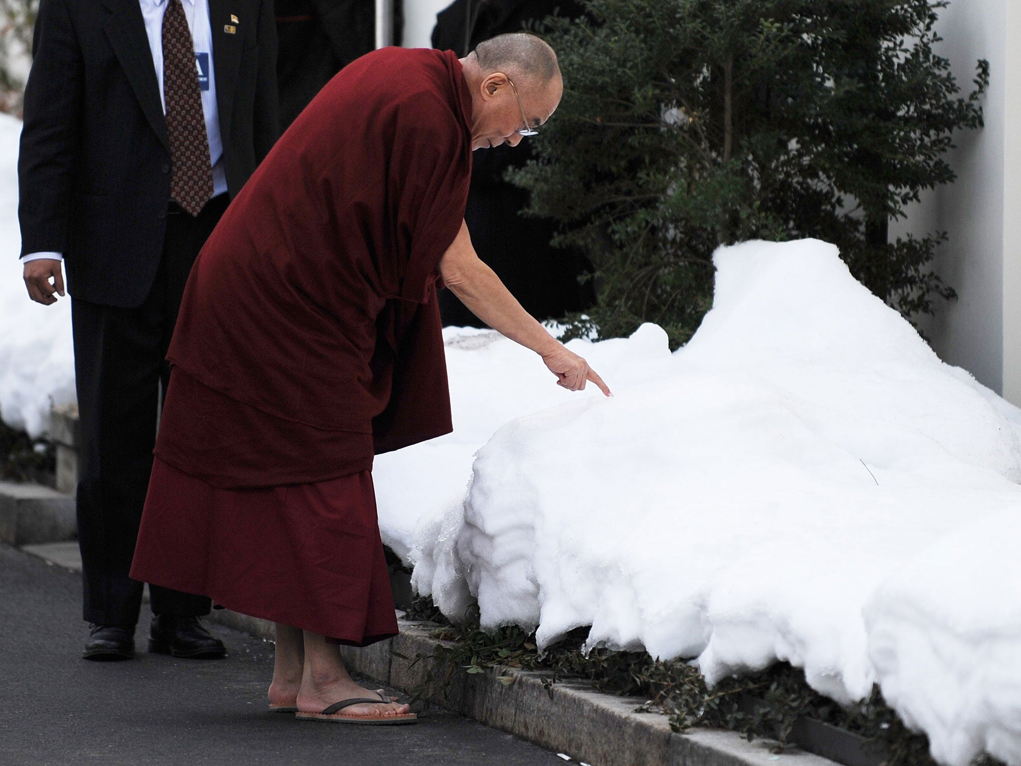 The Dalai Lama draws in the snow with his finger during his 2010 Washington DC visit (AFP/Getty Images)