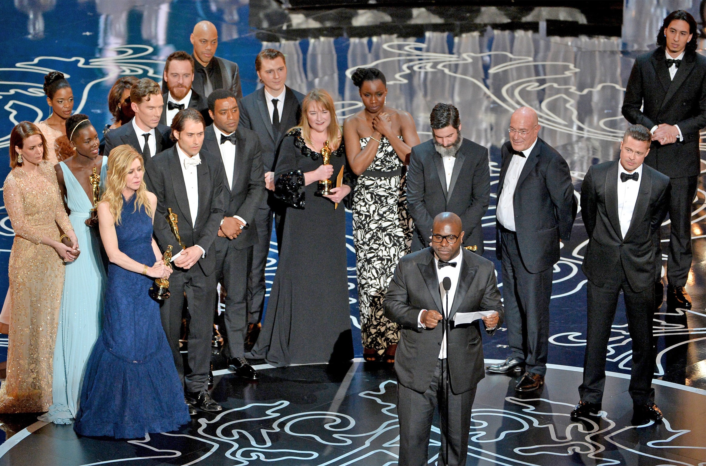 ‘12 Years A Slave’ director Steve McQueen accepts his award for Best Picture at the Oscars. Screenwriter John Ridley can be seen at the very back, behind actor Chiwetel Ejiofor