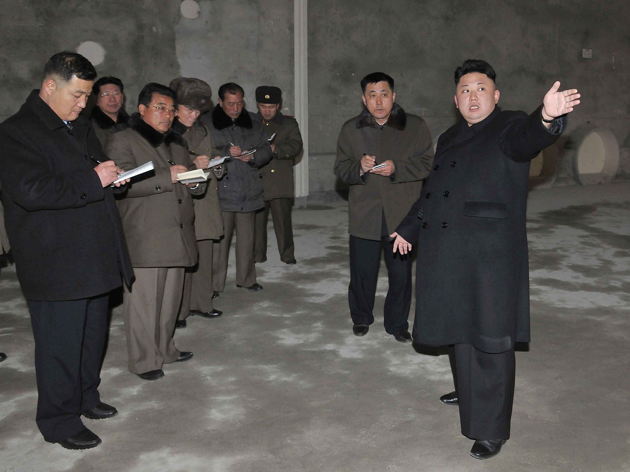 Kim Jong-Un points at remodeled building of the Songdowon International Children's Camp in Kangwon Province 