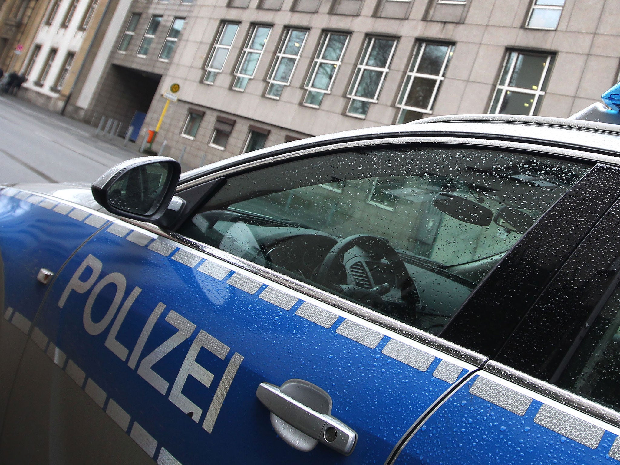 A German police car stands, unrelated to the incident in Bavaria where a headmistress in now under investigation for shouting a Nazi salute at children.