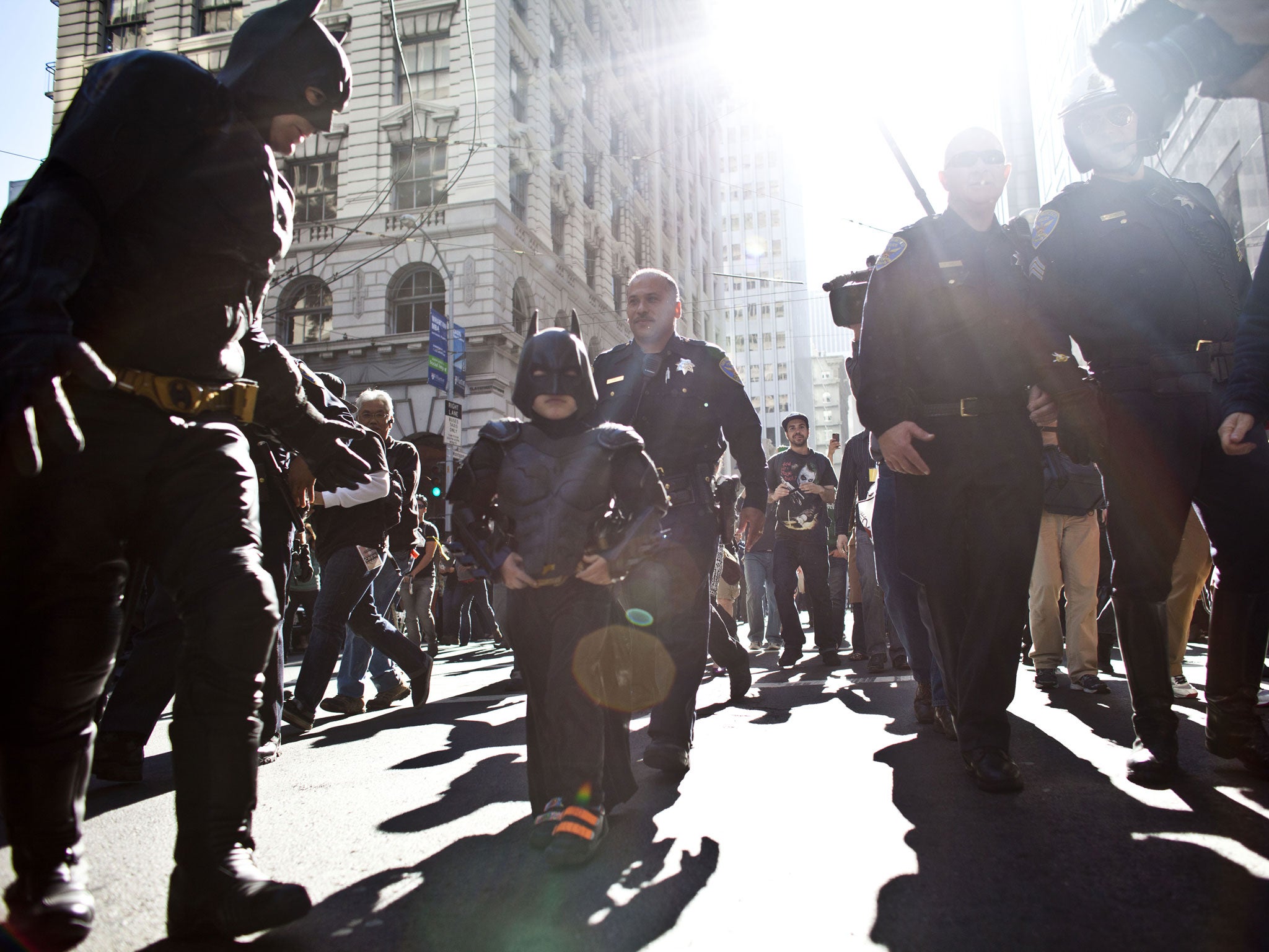 Batkid accompanied by Batman on the streets of San Francisco