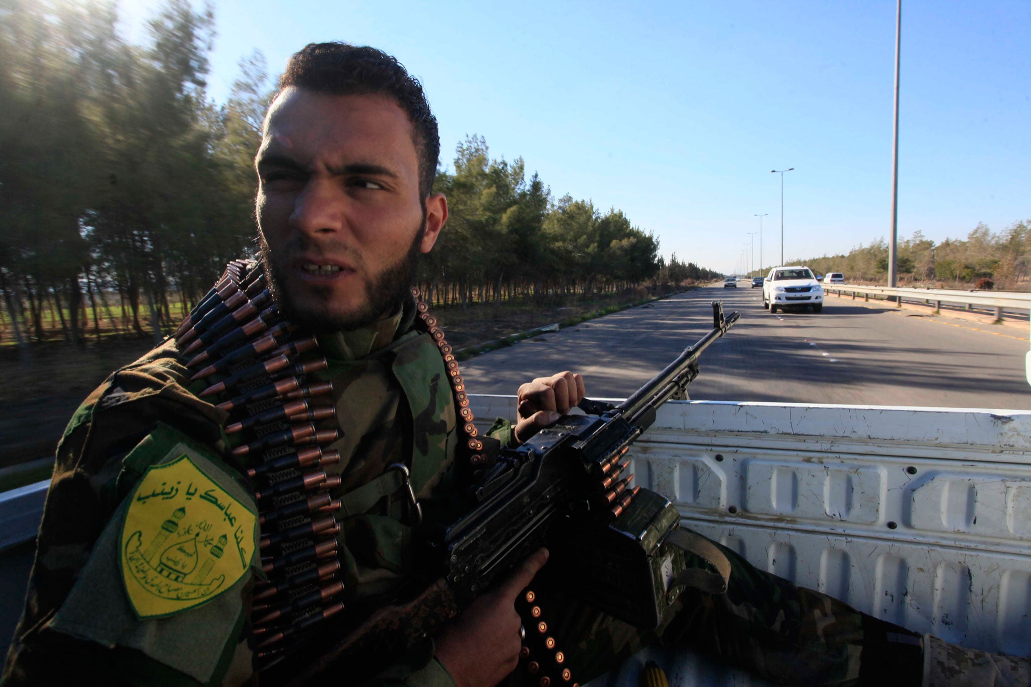 An Iraqi Shiite fighter patrols the outskirts of Damascus