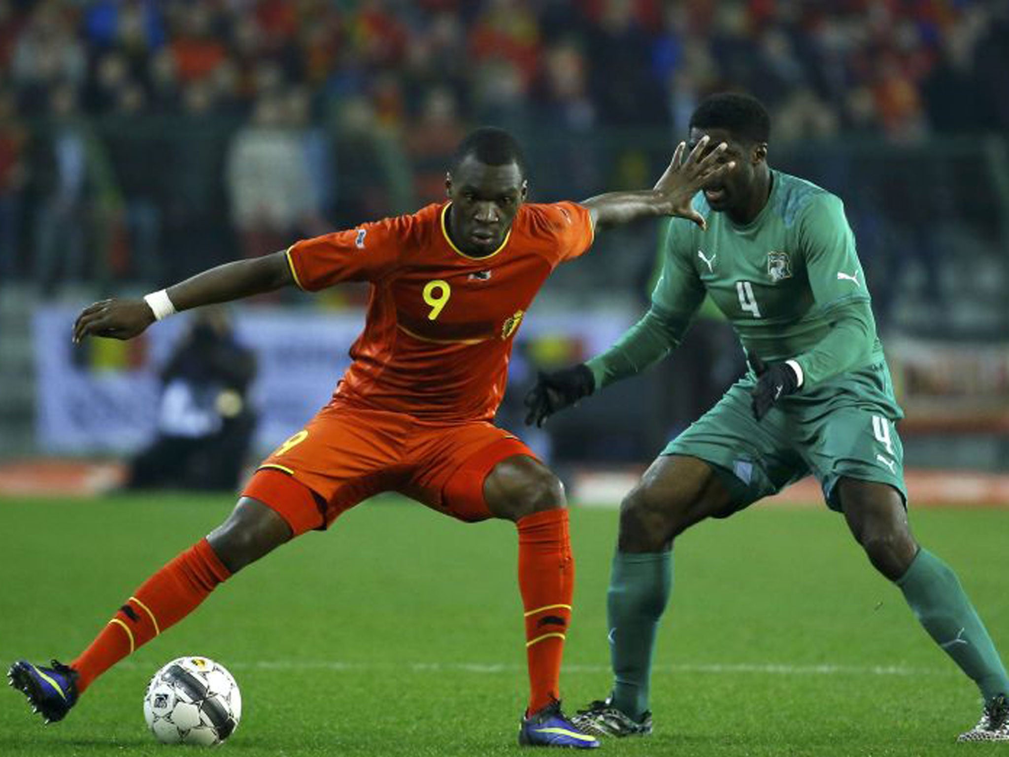 Belgium striker Christian Benteke holds off Ivory Coast defender Kolo Toure