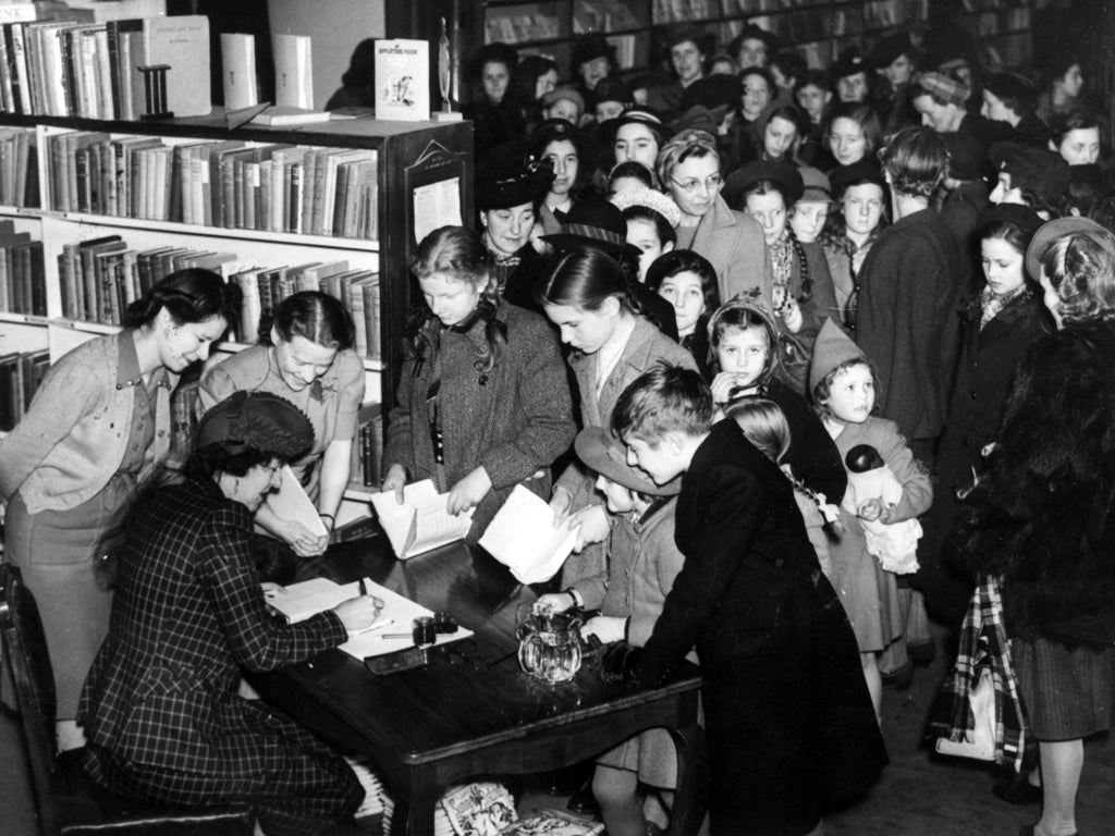 People queuing for the autograph of Enid Blyton, the English children's author, at a Brompton store.