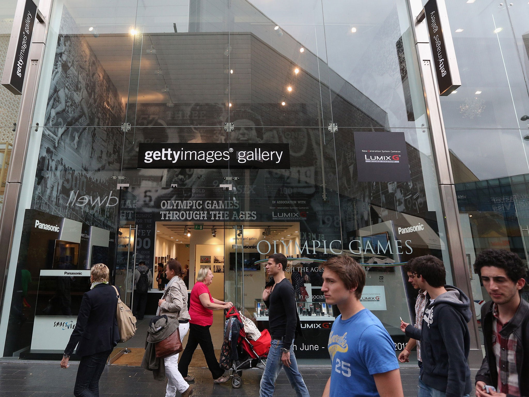 Shoppers walk past the Getty Images gallery in London