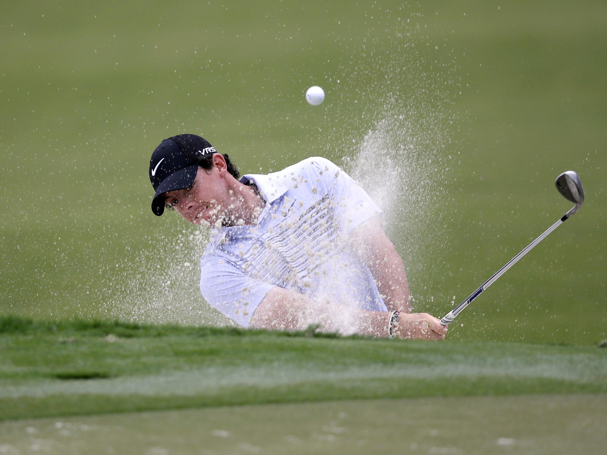 Rory McIlroy of Northern Ireland, hits from a 12th hole sand trap during the first round of the Cadillac Championship golf tournament