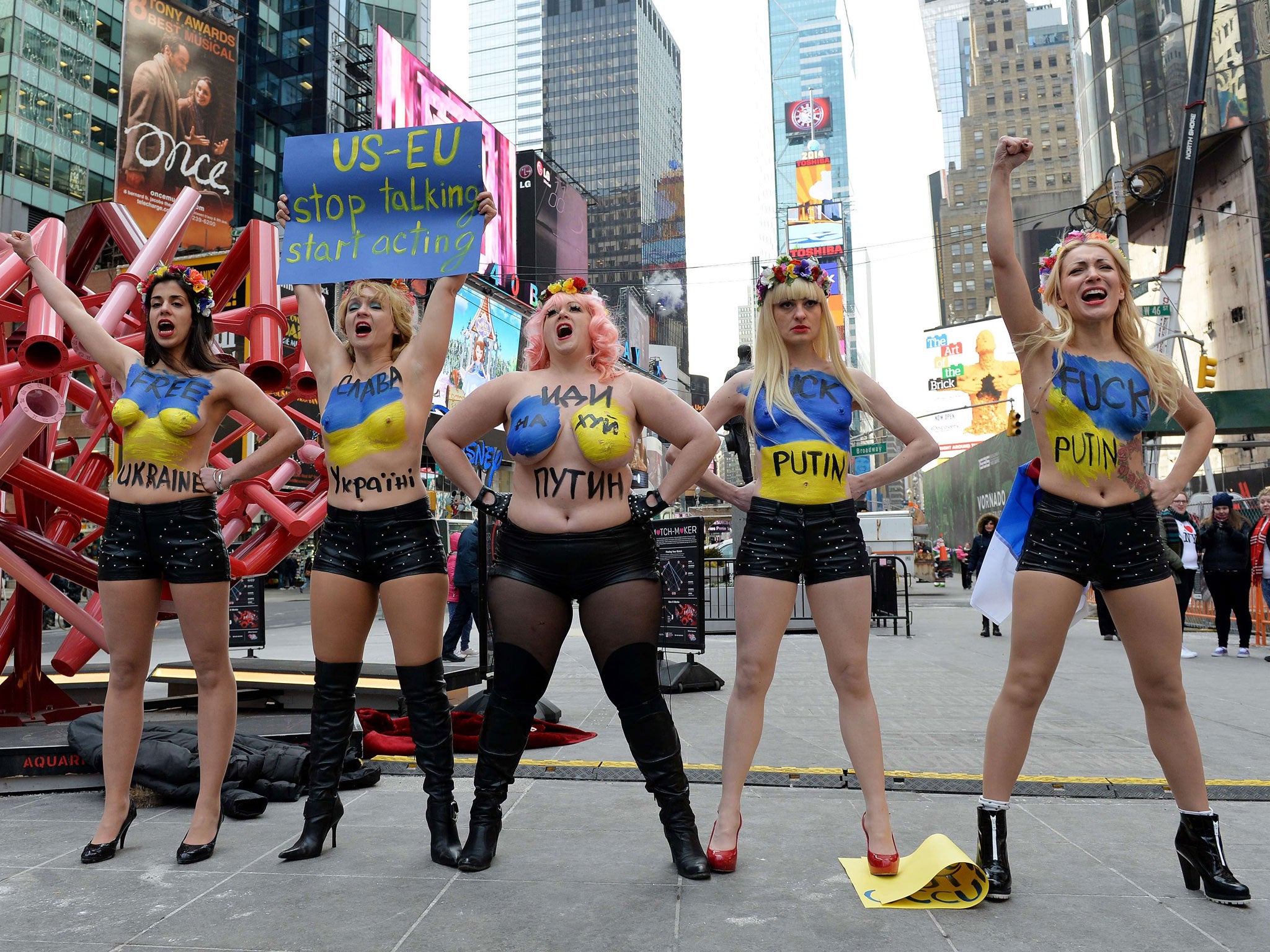 Topless activists of the Ukrainian protest group FEMEN demonstrates against Russian intervention in Ukraine and in support of US sanctions in New York's Times Square