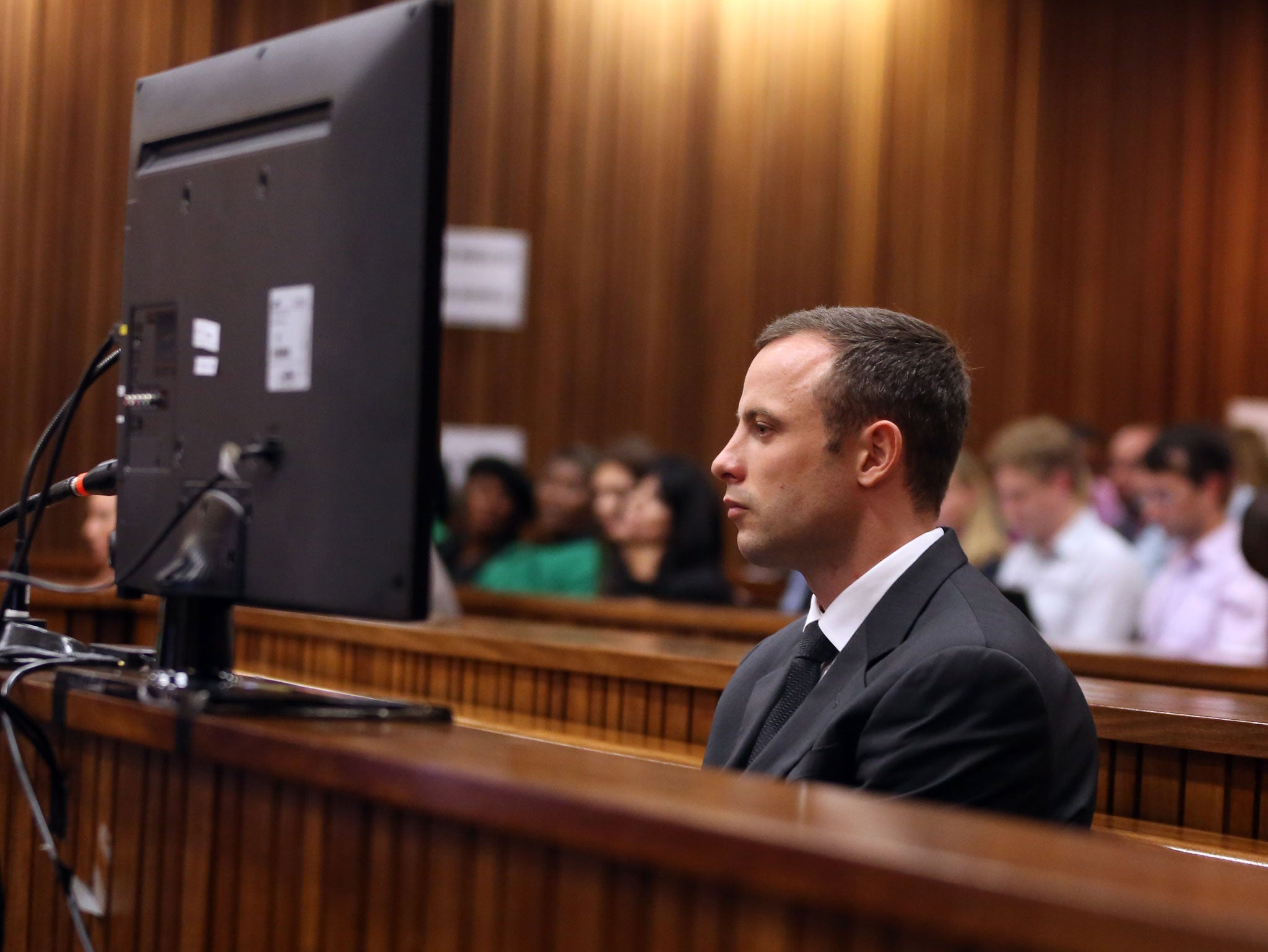South African paralympic athlete Oscar Pistorius listens at the Pretoria's North Gauteng High Court on March 7, 2014, during the 5th day of his trial for the 2013 murder of his girlfriend Reeva Steenkamp