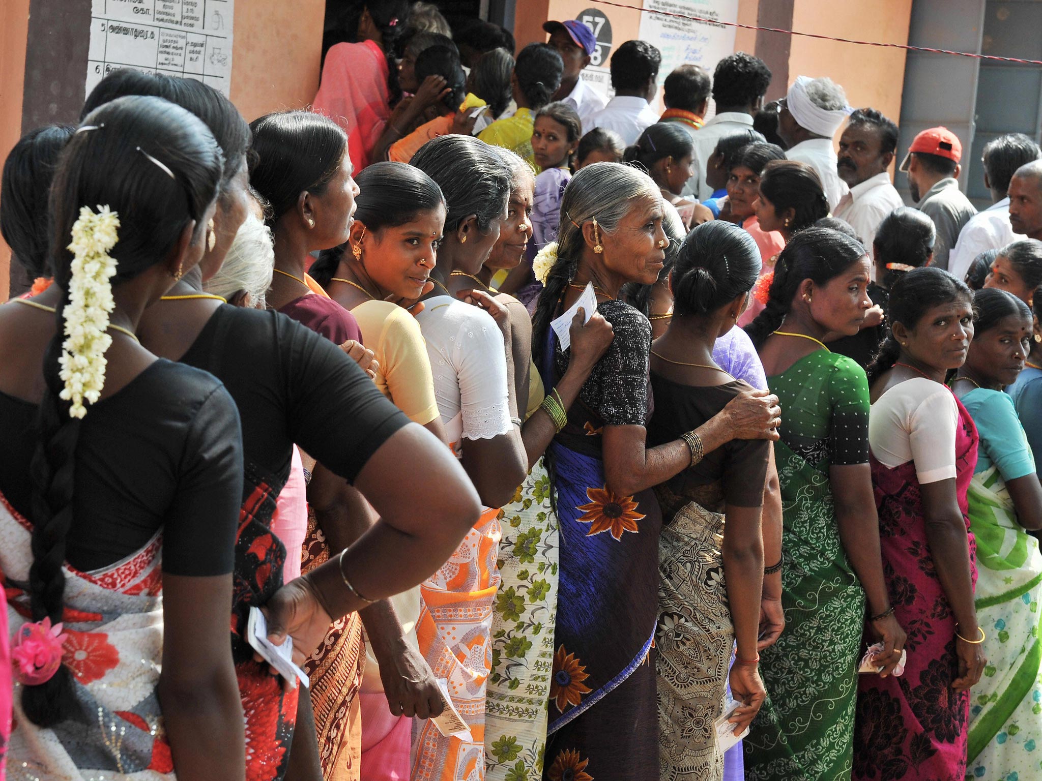 Indian women queue outside an election polling booth. Just under 390 million women are registered to vote in the coming general election
