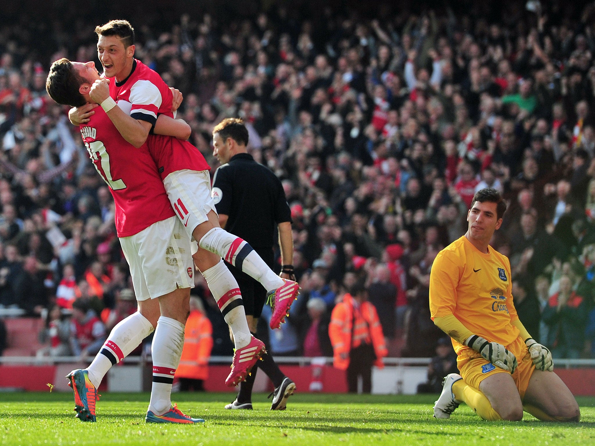 Olivier Giroud (left) and Mesut Ozil celebrate for Arsenal against Everton on Sunday