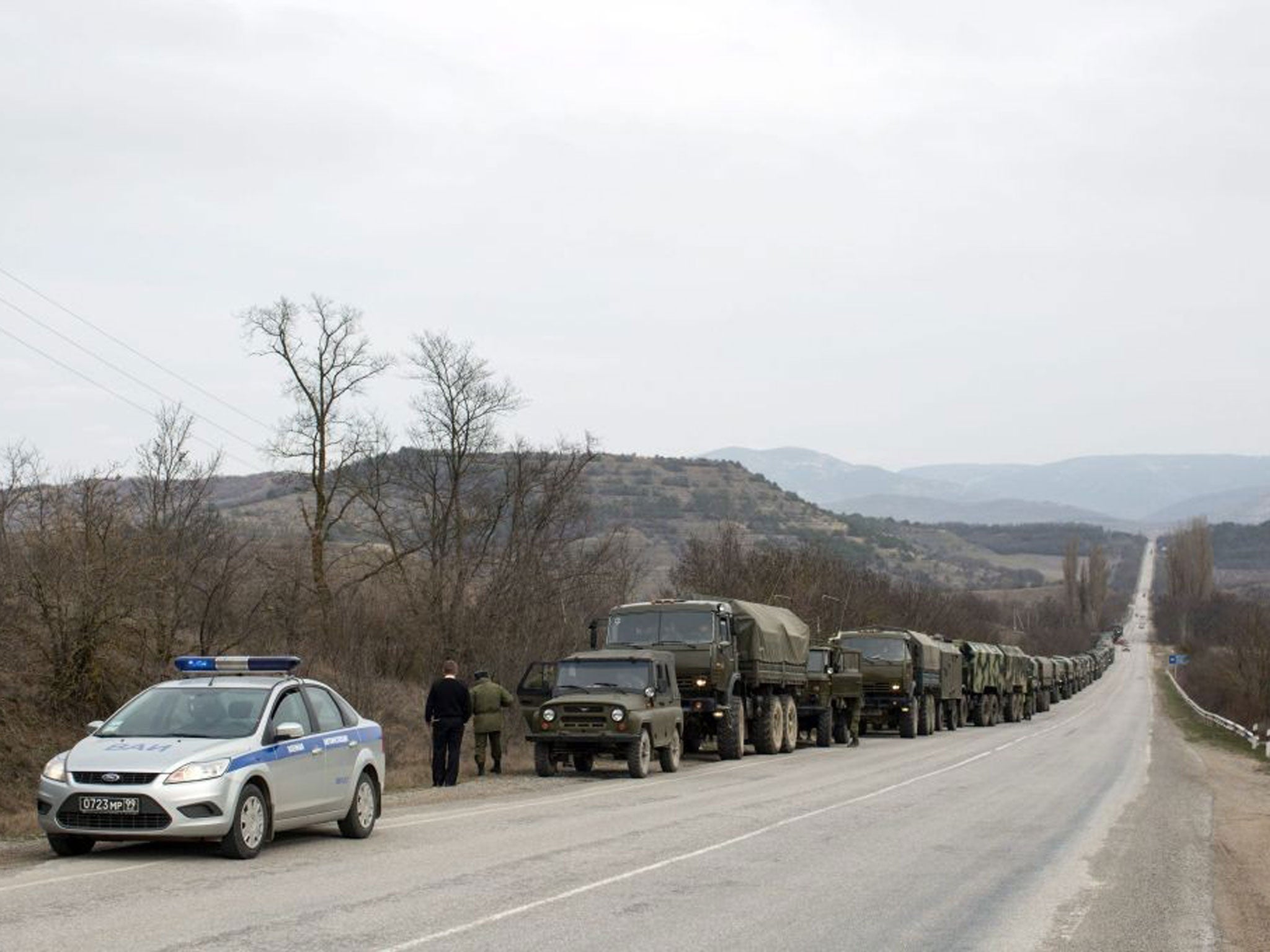 Russian troops stand on a roadside in the settlement of Opytnoye, some 70 kilometres from Simferopol.