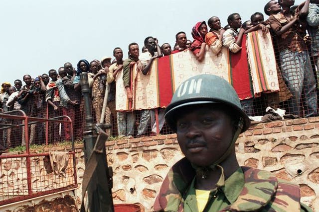 A Ghanaian UN soldier watches over Tutsi refugees being led from a Kigali church in June 1994 