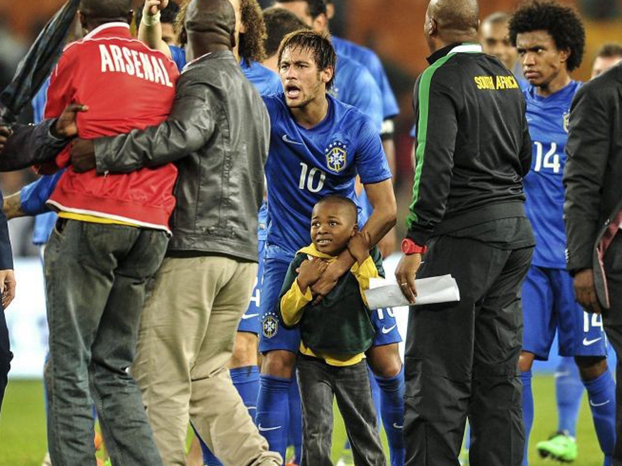 Neymar shows his boyish side when he scooped up this little pitch invader earlier in the week