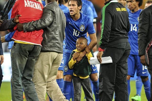 Neymar shows his boyish side when he scooped up this little pitch invader earlier in the week