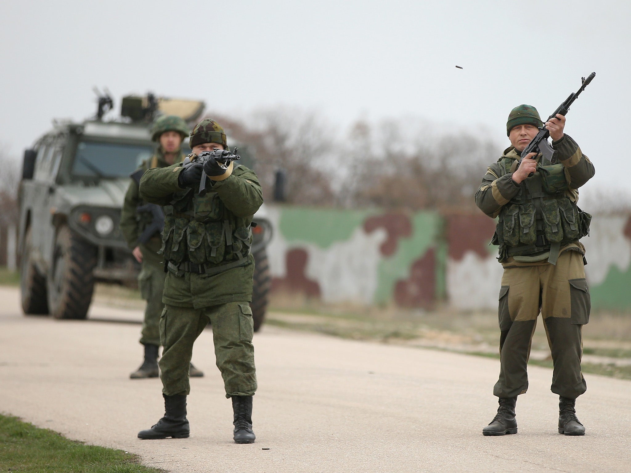 File image: Troops under Russian command fire weapons into the air as an approaching group of over 100 hundred unarmed Ukrainian troops at the Belbek airbase, which the Russian troops are occcupying in Crimea