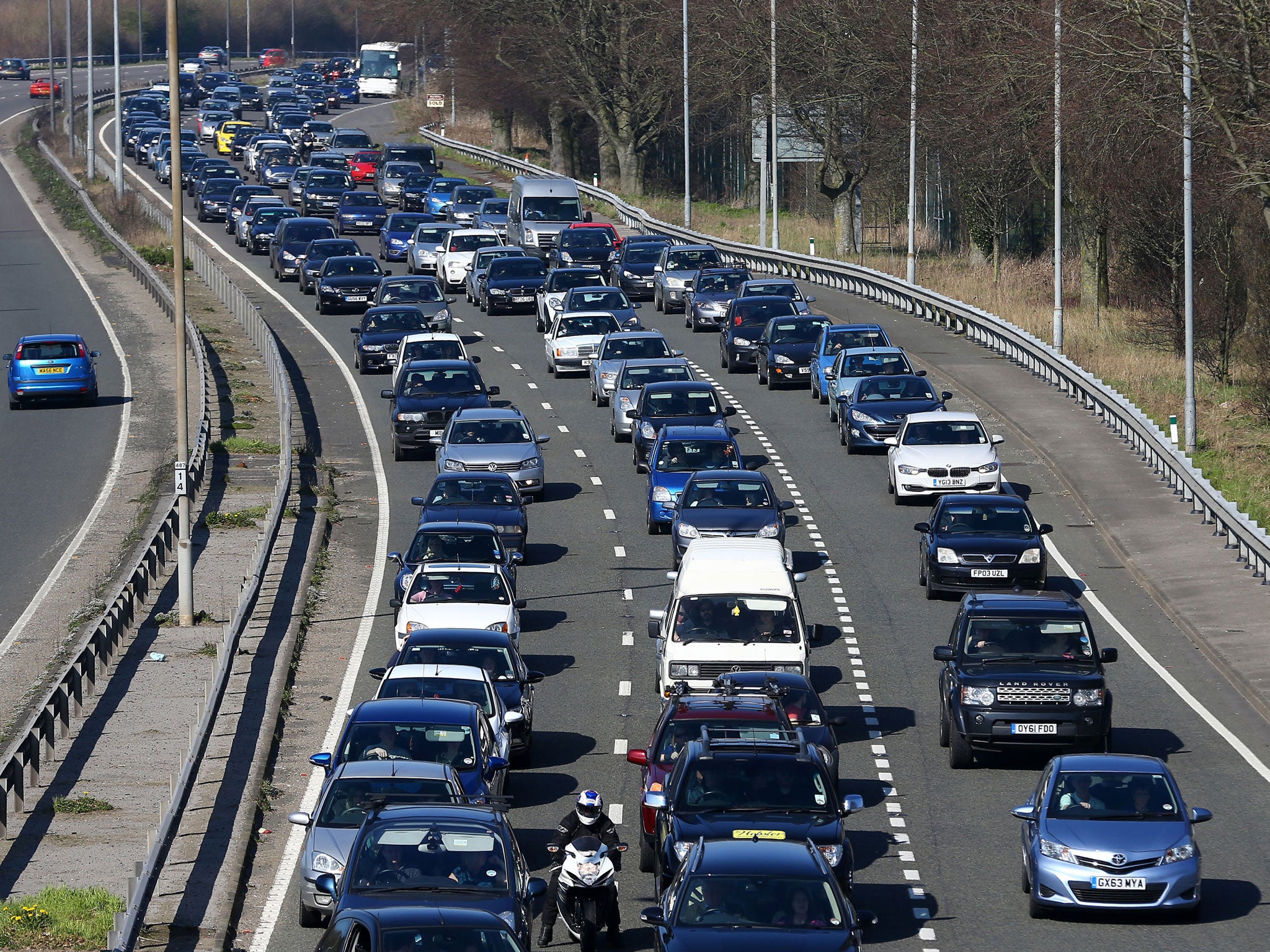 Cars queue on the A23 near Brighton, East Sussex, as visitors to the city take advantage of the warm weather (PA)