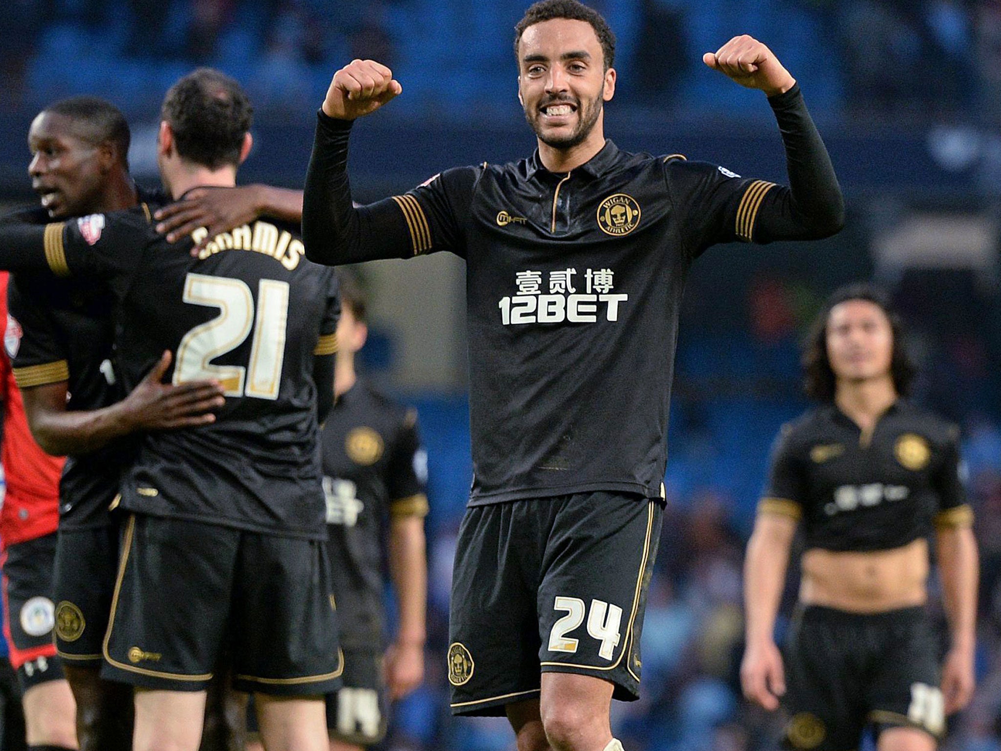 Wigan Athletic's James Perch celebrates at the final whistle after his goal helped knock Manchester City out of the FA Cup at the Etihad Stadium