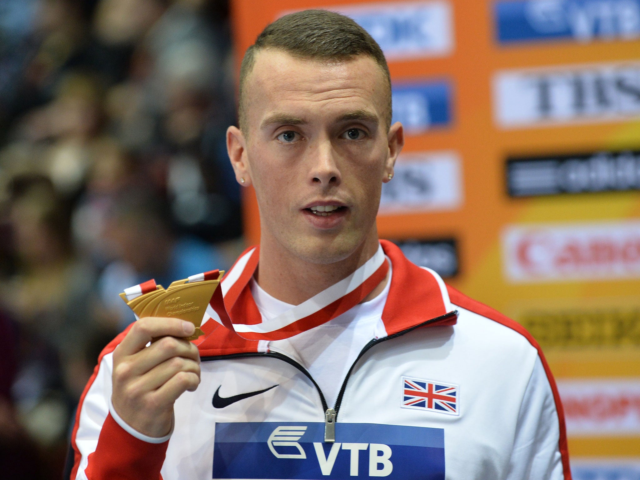 Gold medalist Great Britain's Richard Kilty celebrates on the podium of the Men 60m Final