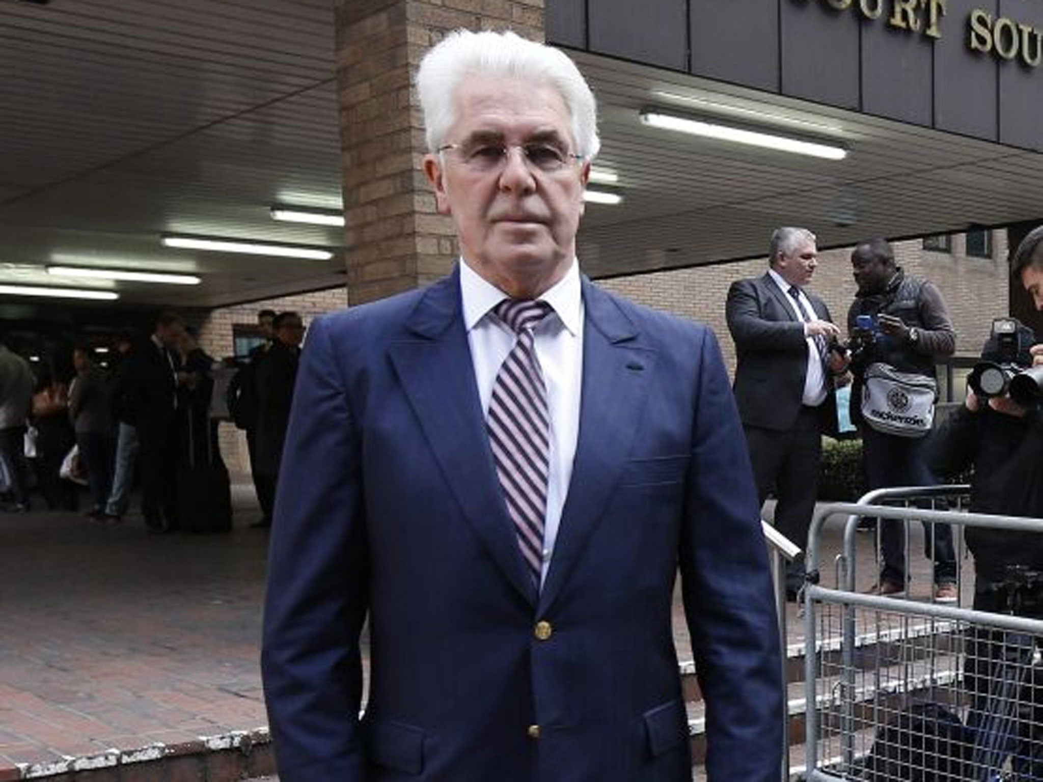 Publicist Max Clifford poses for photographers as he arrives at Southwark Crown Court in central London on 10 March.