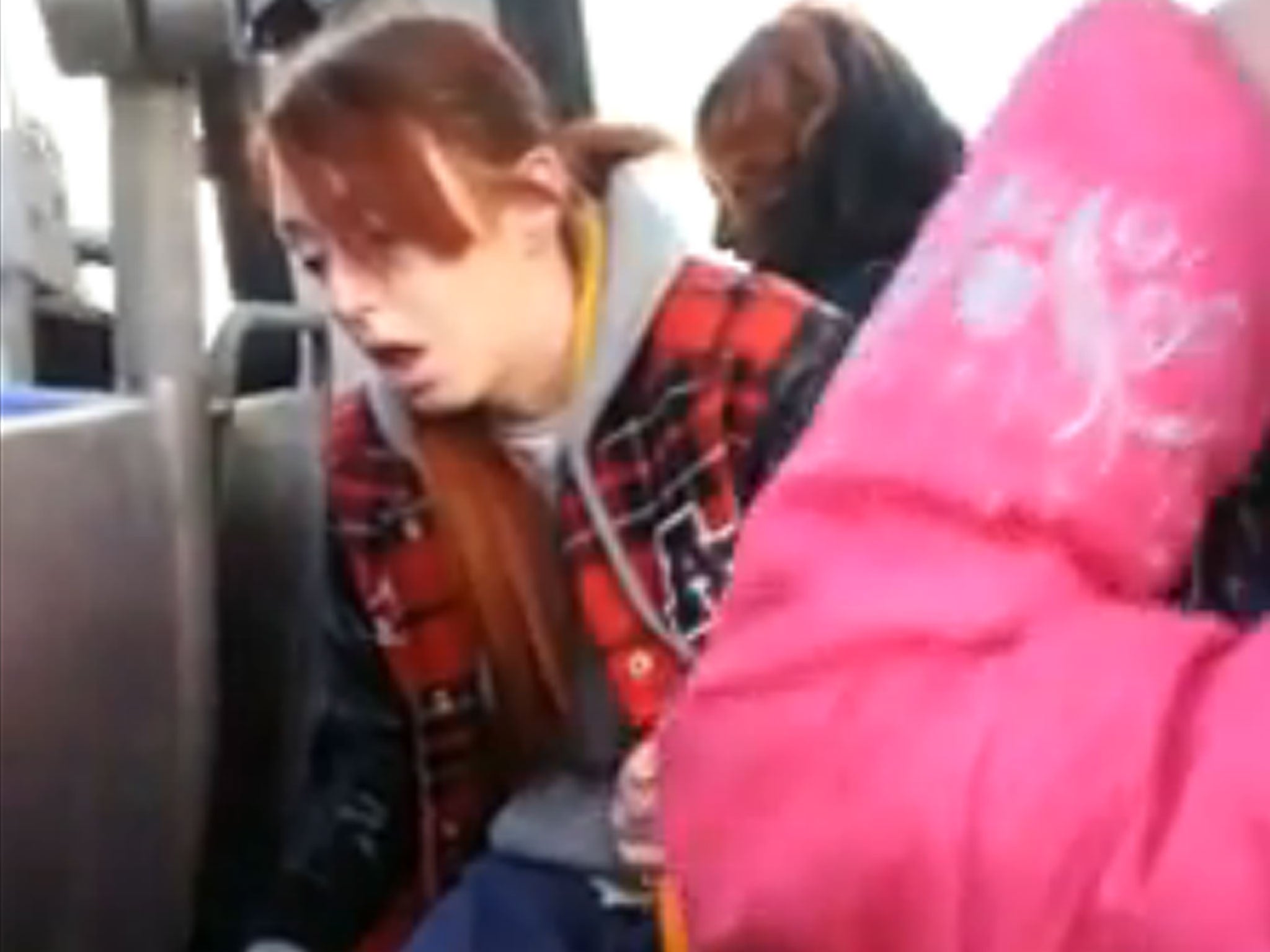 A still from a video uploaded to Facebook which shows what is believed to be a high mother and her daughter on a bus