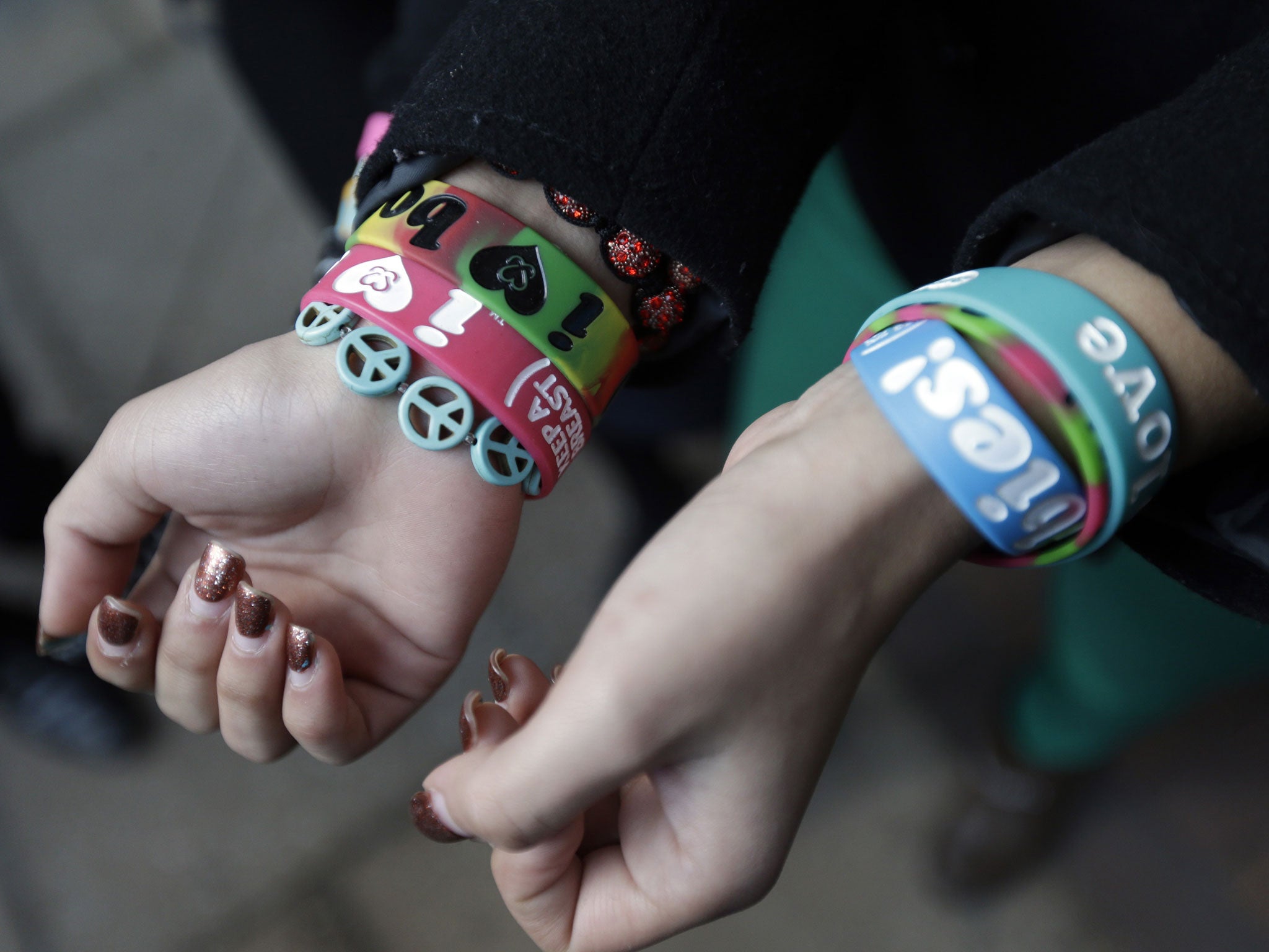 Easton Area School District student Kayla Martinez displays her bracelets for photographers outside the U.S. Courthouse in Philadelphia