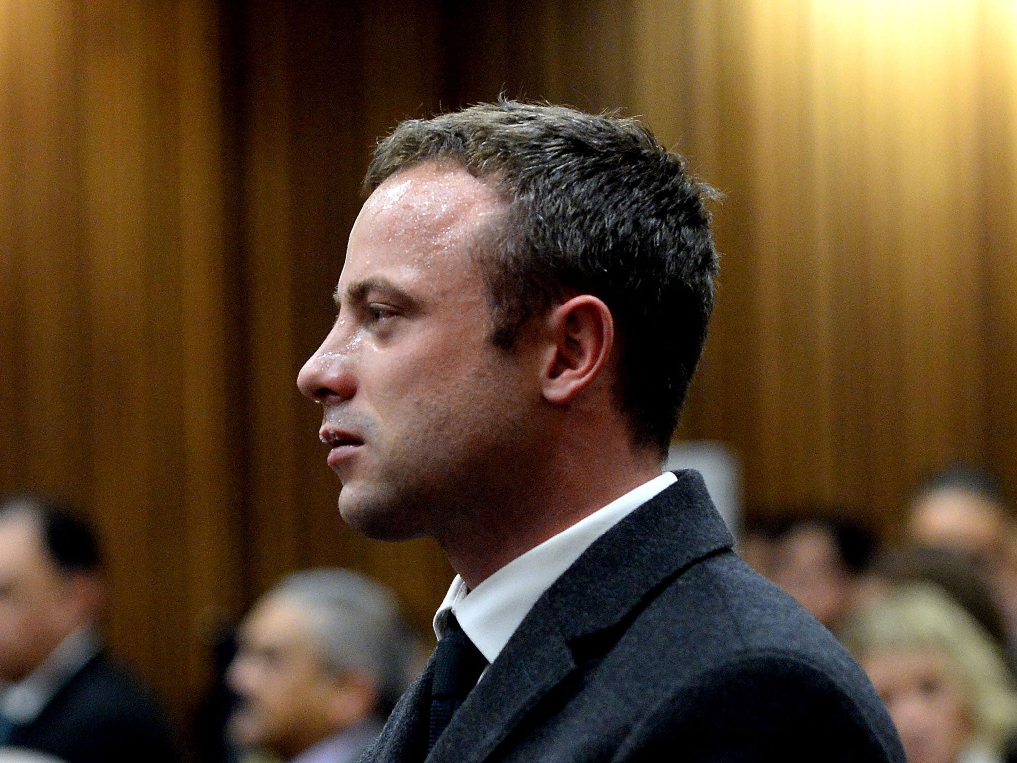 Oscar Pistorius cries as he listens to cross questioning about the events surrounding the shooting death of his girlfriend Reeva Steenkamp, in court during his trial in Pretoria