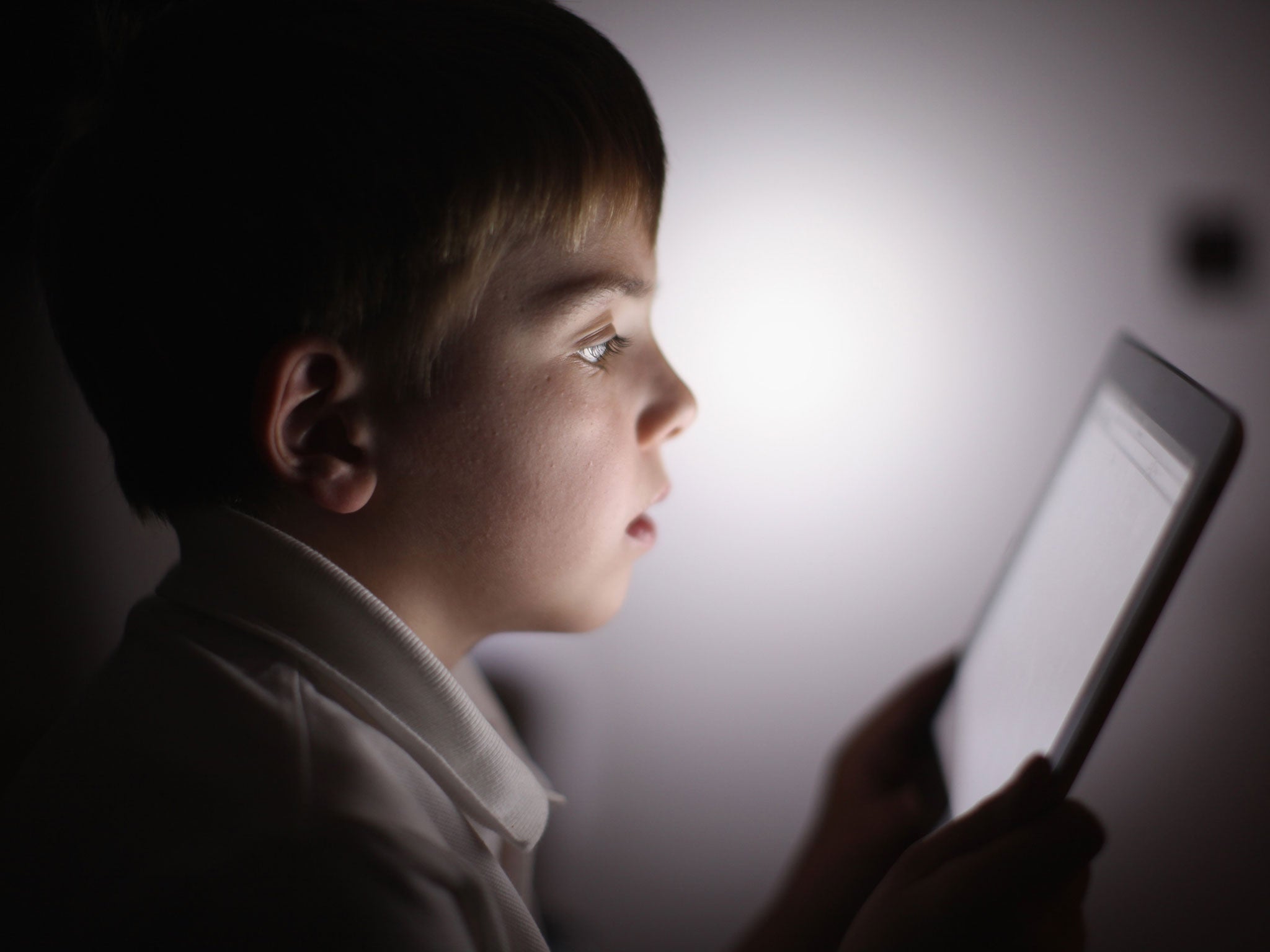 In this photograph illustration a ten-year-old boy uses an Apple Ipad tablet computer on November 29, 2011 in Knutsford, United Kingdom. Tablet computers have become the most wanted Christmas present for children between the ages of 6-11 years. Many paren
