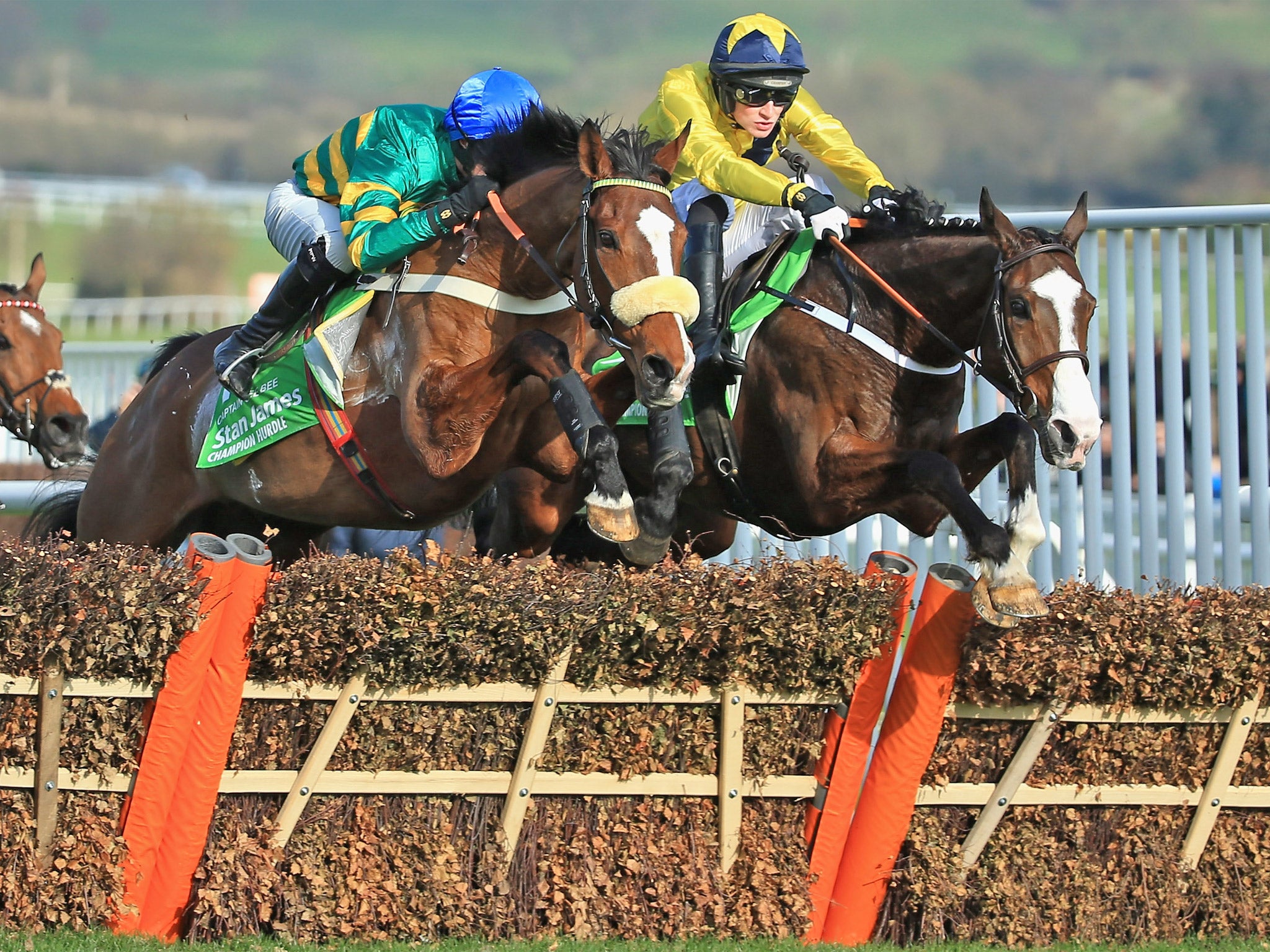 Daniel Mullins on Our Conor (right) briefly leads the field featuring eventual winner Jezki, ridden by Barry Geraghty (left)