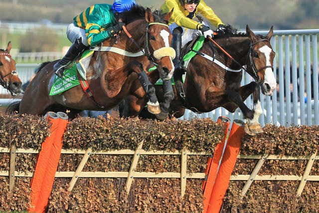 Daniel Mullins on Our Conor (right) briefly leads the field featuring eventual winner Jezki, ridden by Barry Geraghty (left)