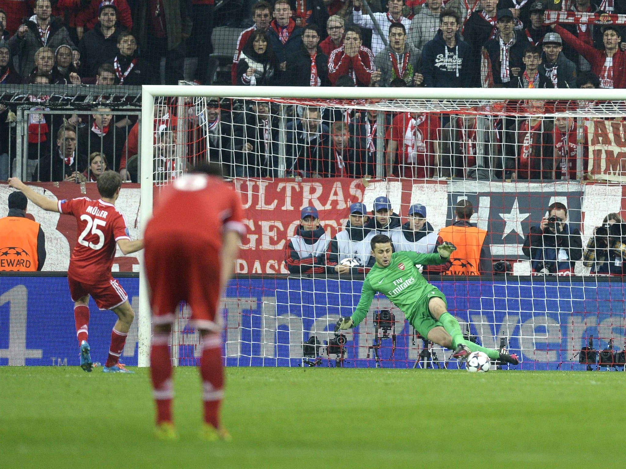 Lukasz Fabianski uses his legs to save Thomas Muller's penalty