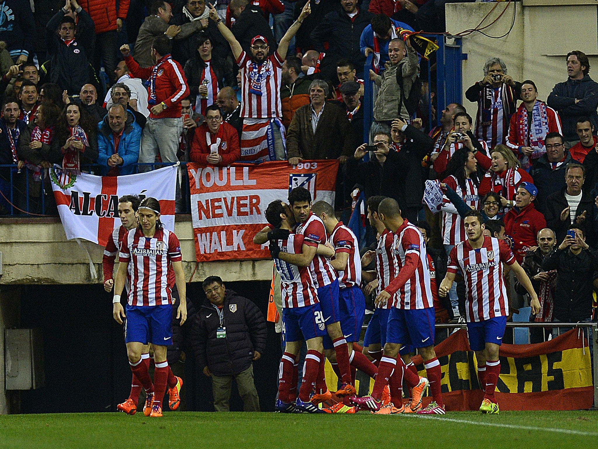 Atletico Madrid's Brazilian-born forward Diego Costa (C) celebrates after scoring during the UEFA Champions League quarter-final second leg football match Club Atletico de Madrid vs AC Milan