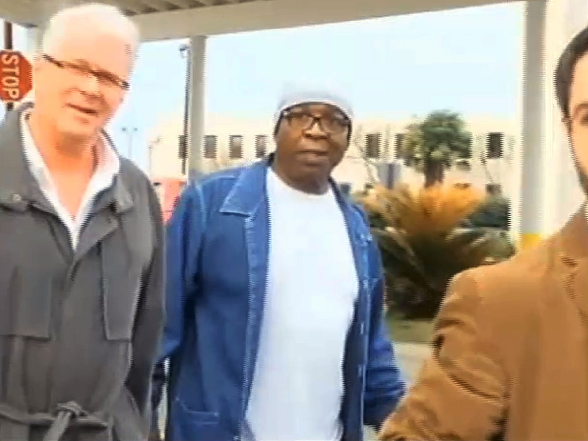 Glenn Ford, 64, center, walks out of a maximum security prison