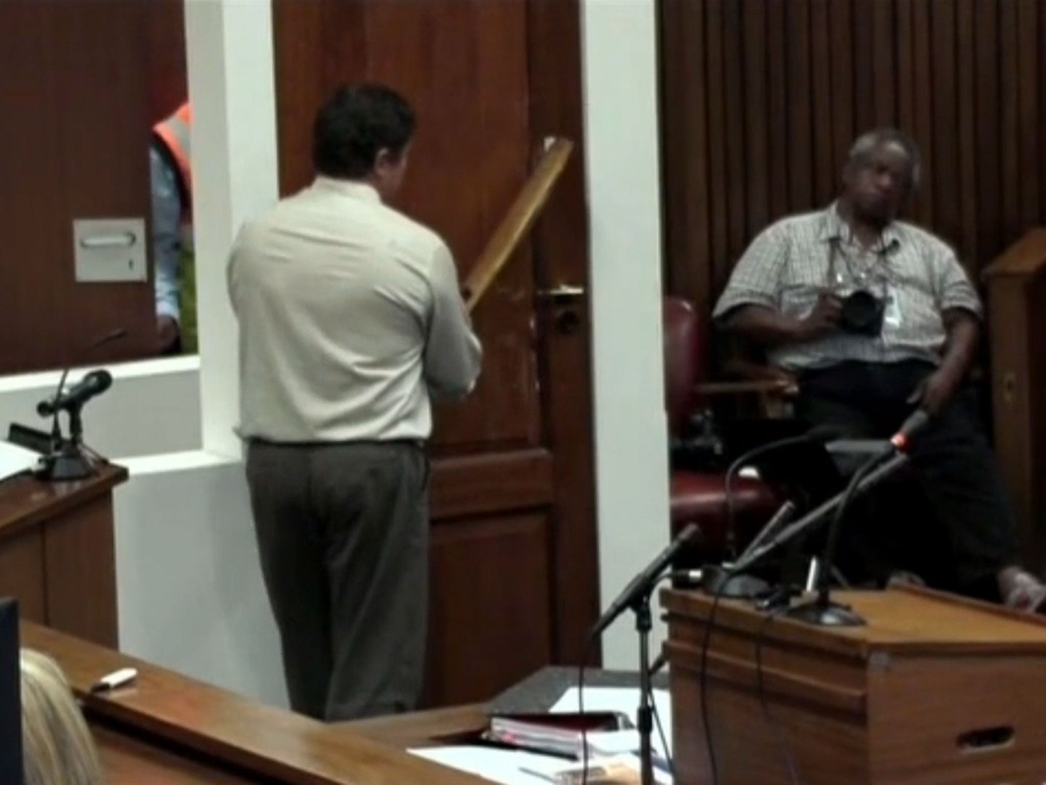 Forensic analyst demonstrates how Pistorius allegedly used a cricket bat to knock through door to get to dying girlfriend
