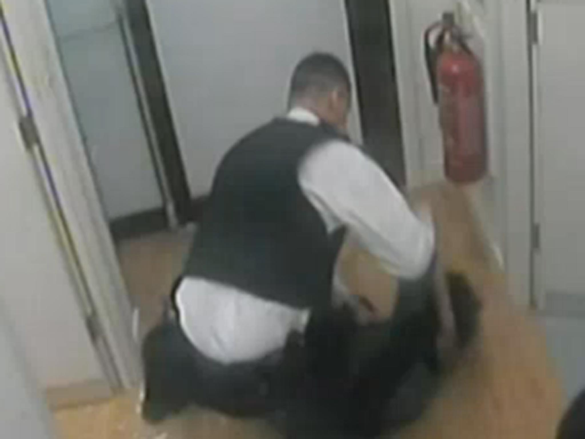 A shot from the CCTV shows the officer punch the woman