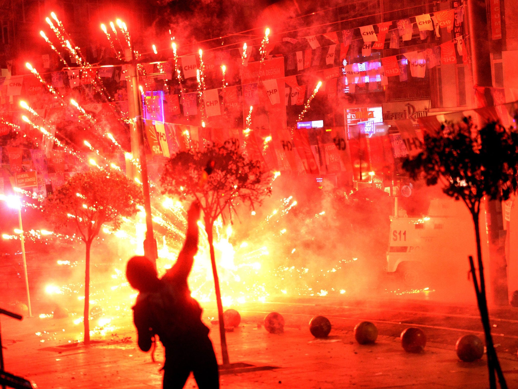 Fireworks thrown by protesters against Turkish riot police explodes and illuminates the scene during a demonstration in Istanbul
